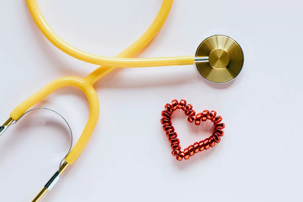 stethoscope and heart broach isolated on a white background, being used to illustrate "How Often Do You Take A Cat To The Vet"
